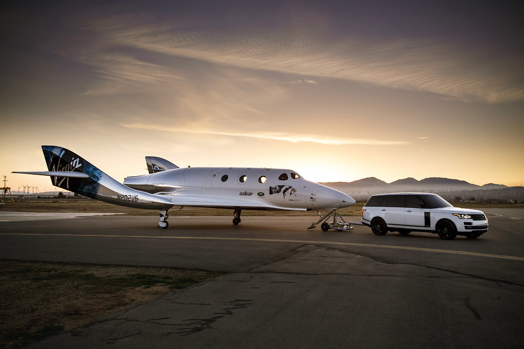 an image of a range rover towing the Virgin Galactic SpaceShipTwo Unity. 