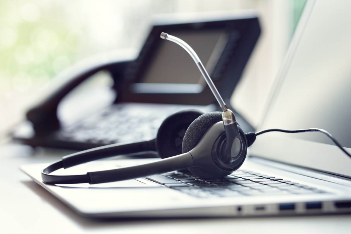 Headset headphones telephone and laptop in call center